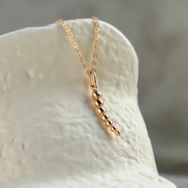 Angled close-up of the CLAUDE diamond necklace pendant
