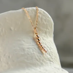 Angled close-up of the CLAUDE diamond necklace pendant