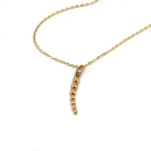 CLAUDE diamond necklace laid out with its pendant visible