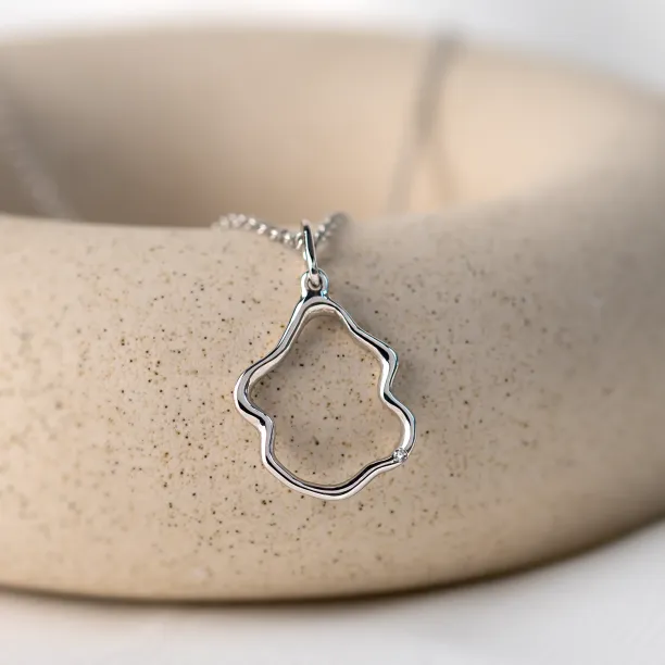Angled close-up of the DOMINIQUE diamond necklace pendant