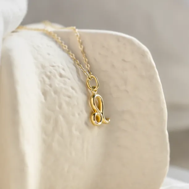 Angled close-up of the Leo necklace and diamond pendant