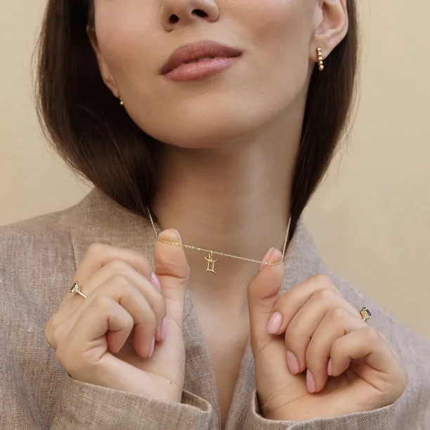 GEMINI diamond necklace worn at the neck and held by hand