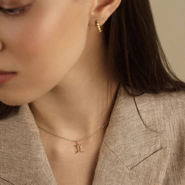Close-up of the GEMINI diamond necklace worn at the neck