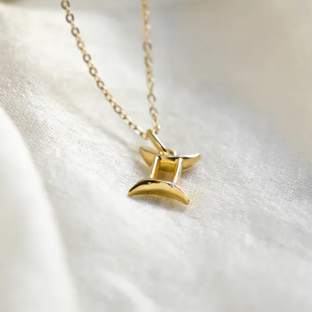 Angled close-up of the GEMINI diamond zodiac pendant