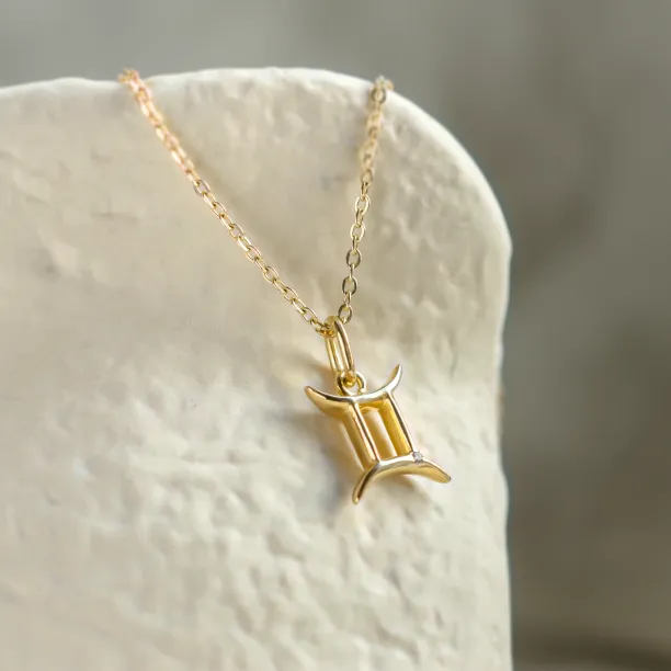 Angled view of the GEMINI diamond zodiac necklace