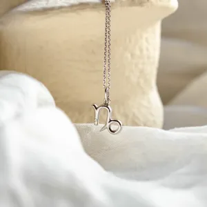 Close-up of the gold diamond CAPRICORN pendant