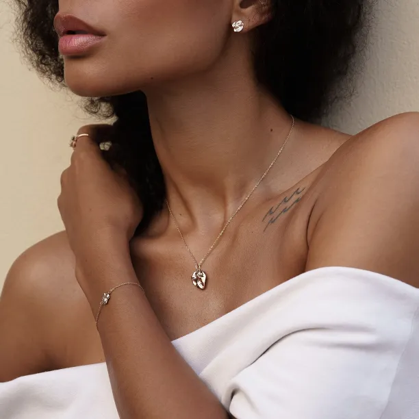 MARGUERITE heart-shaped necklace worn on a person’s neck