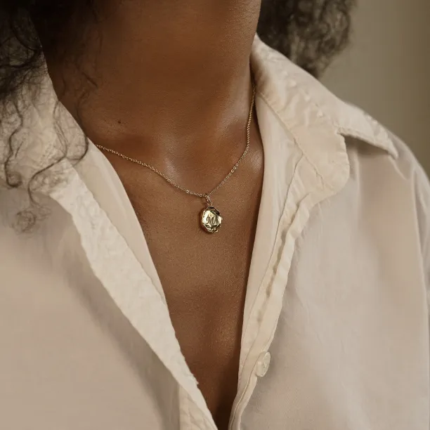 COLETTE personalised diamond necklace worn on the neck with an engraved M pendant