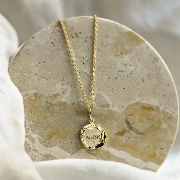 COLETTE personalised diamond necklace with a gold pendant engraved with M&M