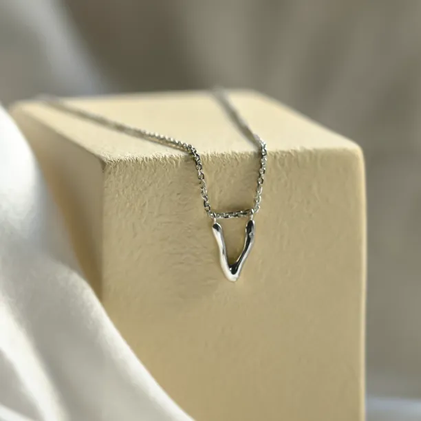 Close-up of the white gold 14K letter pendant with diamond