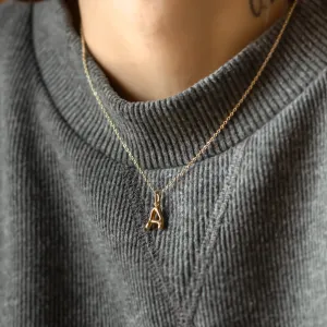 Gold letter A pendant with diamond worn on the neck
