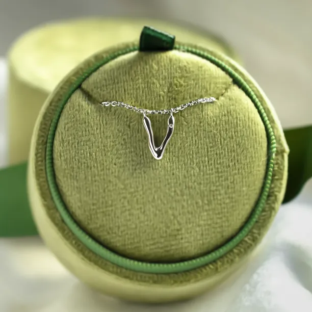 Letter V pendant with diamond displayed on a chain