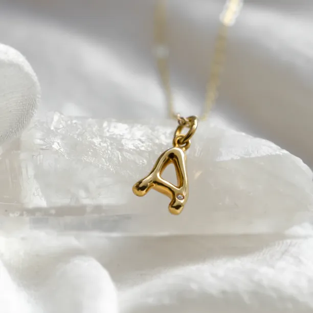Gold letter pendant with diamond JEAN, shown as the letter A