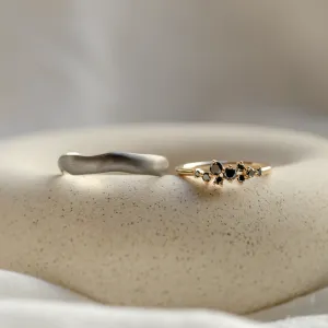 DUE wedding rings separated to show the black rhodium band and diamond ring