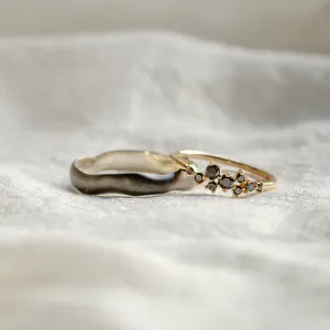 Close-up of DUE black rhodium and black diamond wedding rings together