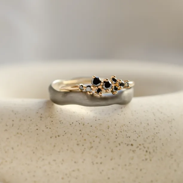 Close-up of the DUE wedding pair with clustered black diamonds