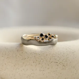 Close-up of the DUE wedding pair with clustered black diamonds