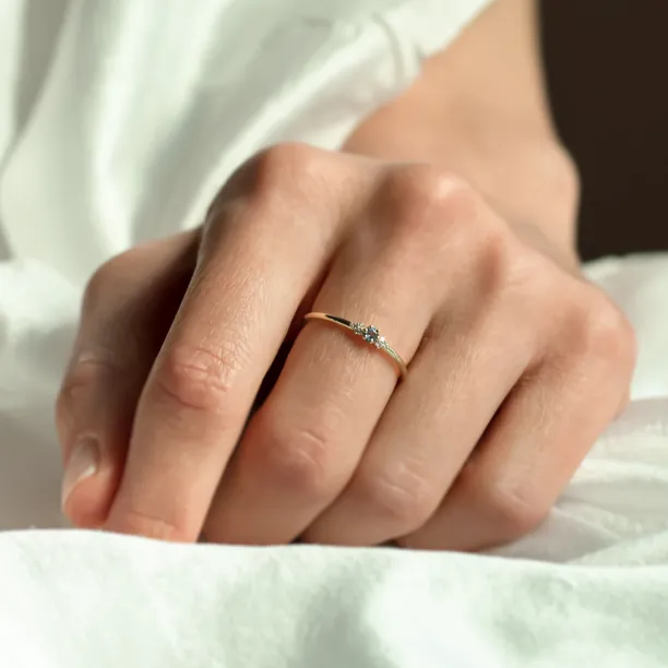 SABINE minimalist sapphire and diamond ring worn on a finger