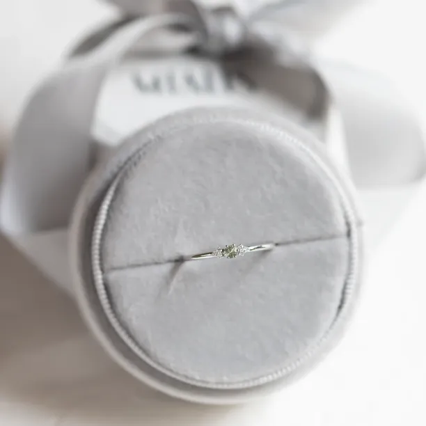 SABINE minimalist ring with sapphire and diamonds displayed on a cushion