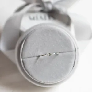 SABINE minimalist ring with sapphire and diamonds displayed on a cushion