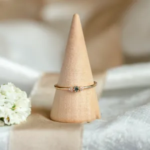 SABINE gold ring with teal sapphire and diamonds displayed on a ring cone