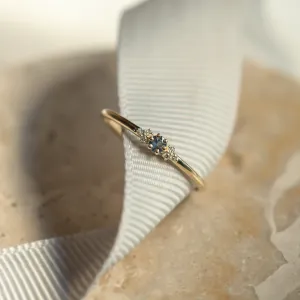Close-up angled view of the SABINE sapphire and diamond ring