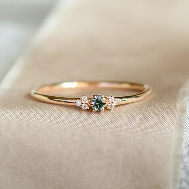 SABINE minimalist gold ring with a teal sapphire and diamonds