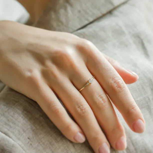 ALICIA gold engagement ring with diamonds worn on a hand