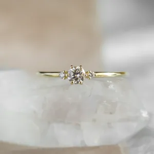 ALICIA gold engagement ring with a central diamond and two side diamonds