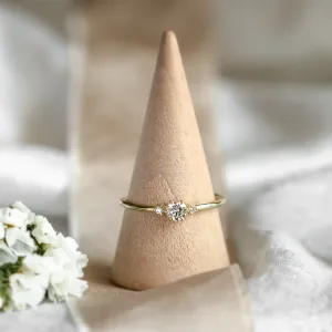 ALICIA gold engagement ring with diamonds displayed on a ring cone