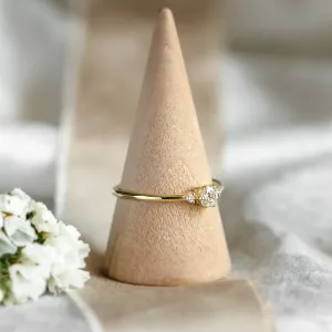 ALICIA gold engagement ring with diamonds, angled view on a ring cone