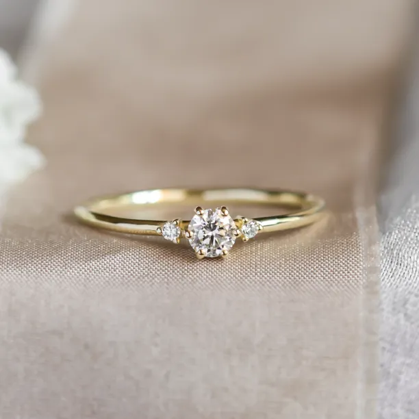 ALICIA gold engagement ring with three diamonds, close-up view