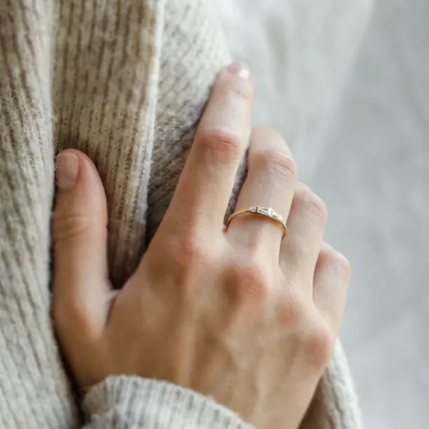 LUMI gold moissanite ring worn on a hand