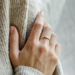 LUMI gold moissanite ring worn on a hand