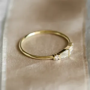 Angled view of LUMI gold ring with baguette and round moissanites