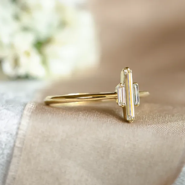 Angled view of the THEA gold engagement ring with baguette moissanites