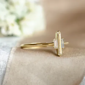 Angled view of the THEA gold engagement ring with baguette moissanites