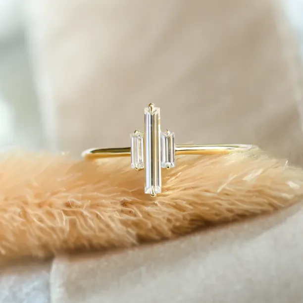 Close-up of the THEA gold engagement ring with three baguette moissanites