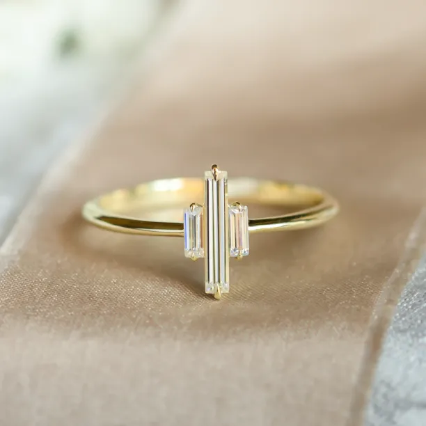 THEA gold engagement ring with three baguette moissanites, close-up view