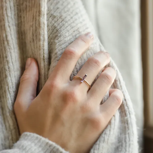 NYX gold ring with baguette amethyst worn on the hand
