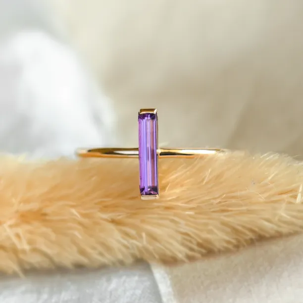 Close-up of the NYX gold ring with baguette amethyst