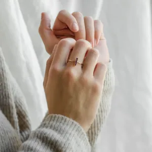 NYX gold ring with baguette amethyst worn on a hand