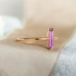 Angled view of the NYX gold ring and baguette amethyst