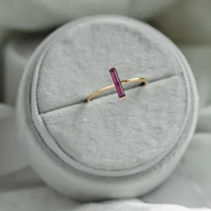 Angled view of the NYX gold ring with baguette amethyst