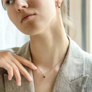 TIA gold earring with moss agate and diamonds worn on the ear