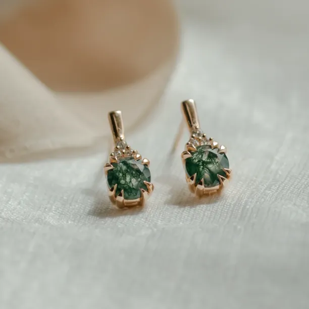 Close-up of TIA gold earrings with moss agate and diamonds