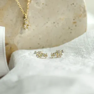 Close-up of ELLY diamond earrings with the pendant in the background