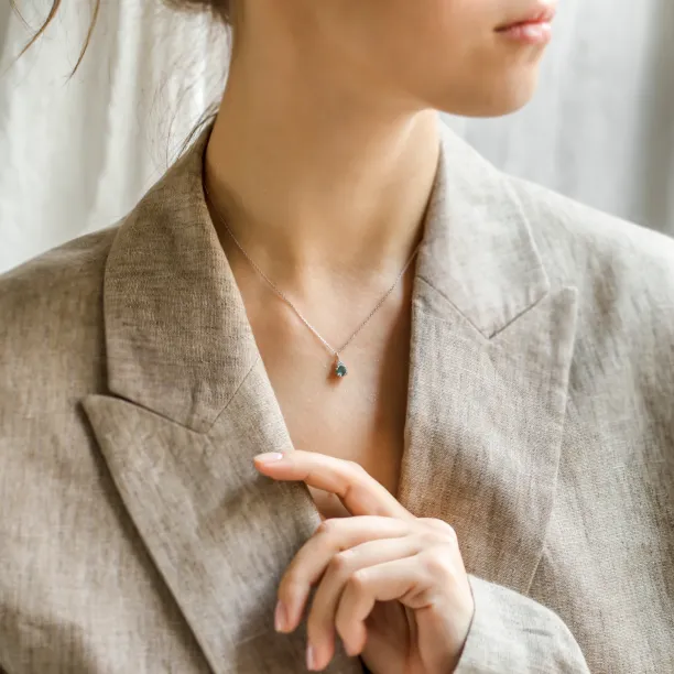 ELANNA emerald and diamond necklace worn on the neck