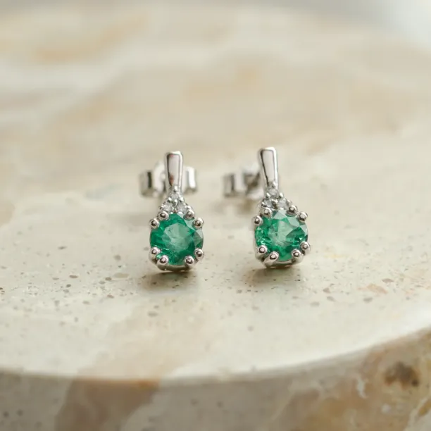 Close-up of emerald and diamond earrings from the ELANNA set