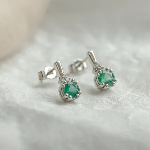 Angled view of LENNY gold earrings with emeralds and diamonds